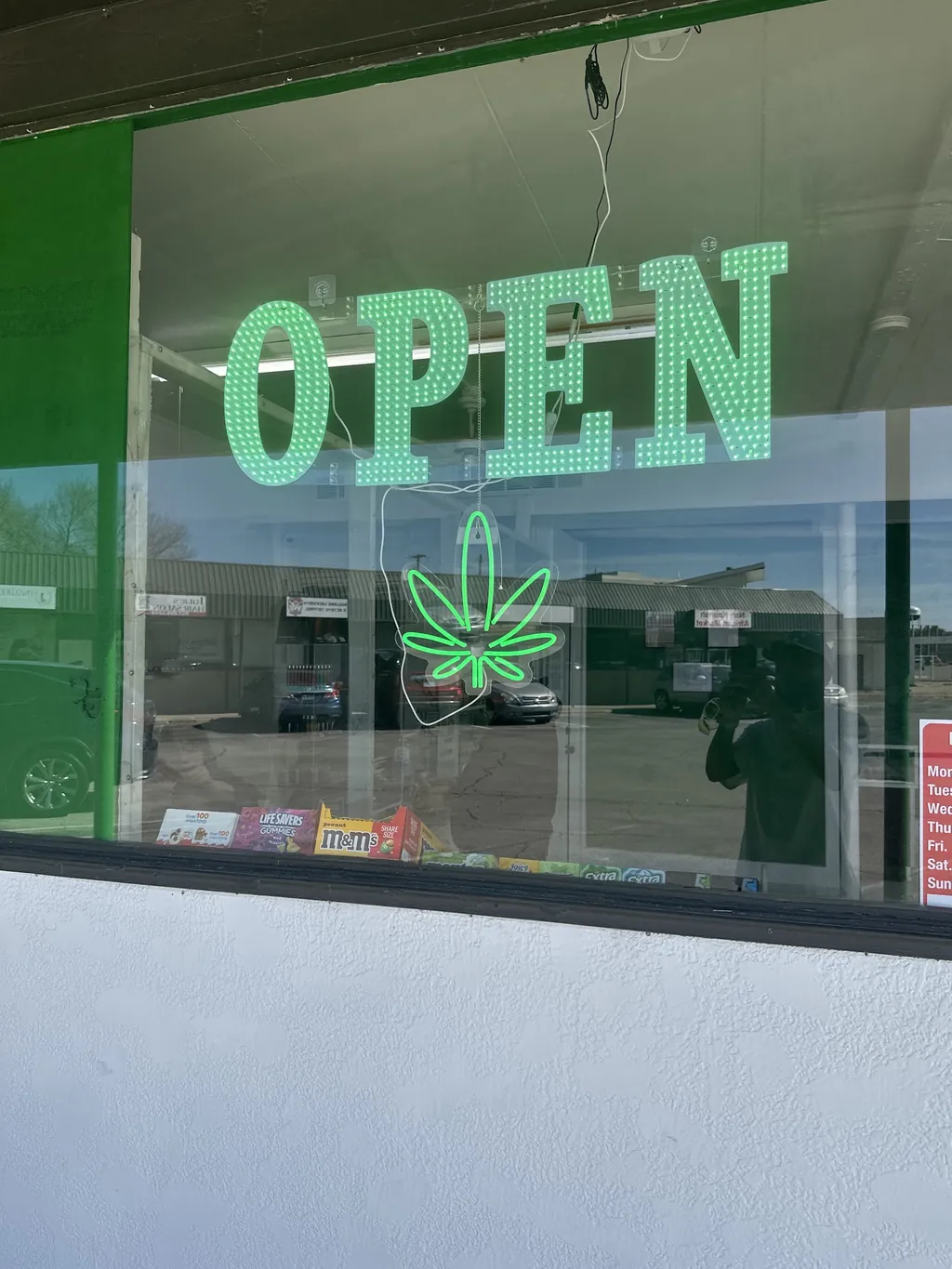 The green OPEN sign in the window at Kush Kingdom Dispensary