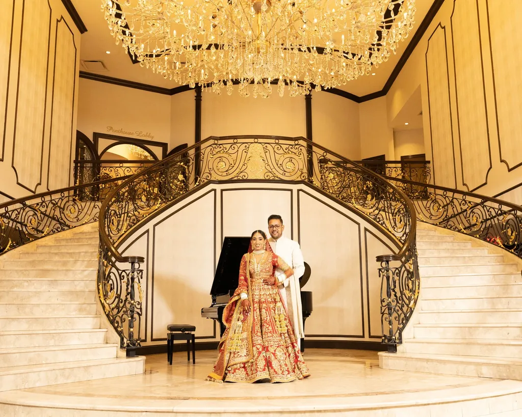 Bride and groom on a marble double staircase