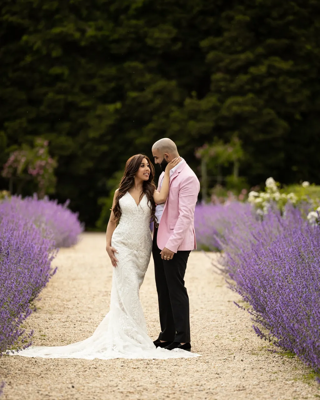 Couple in a lavender garden, she in a white gown
