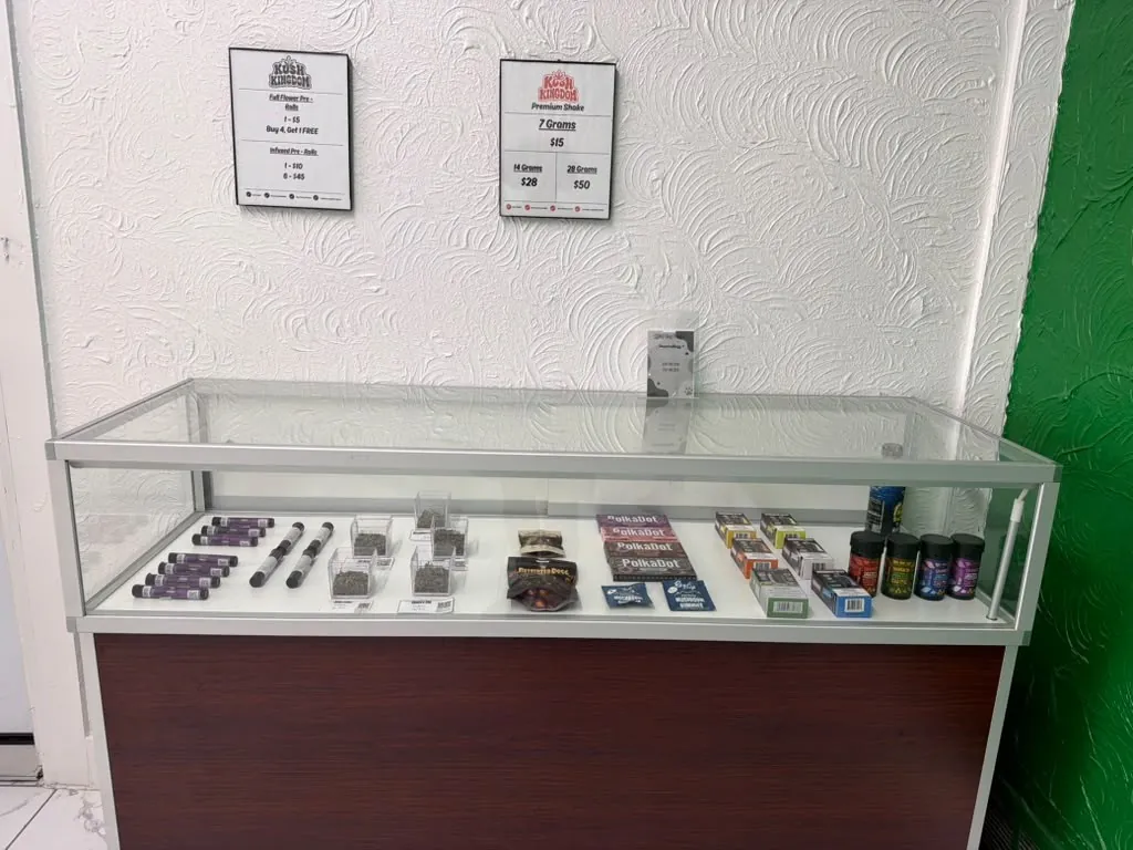 Glass display case with vapes and accessories at Kush Kingdom