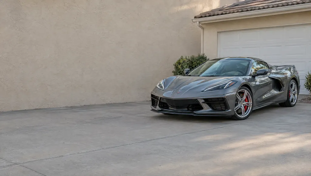 A gray Corvette Stingray parked in a driveway
