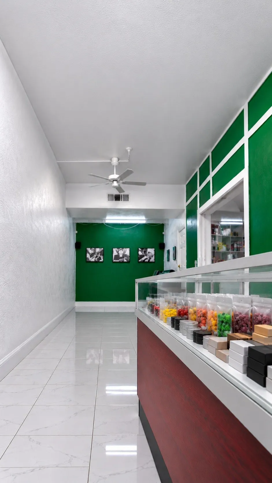 Packs of hemp gummies and edibles in a glass case at Kush Kingdom