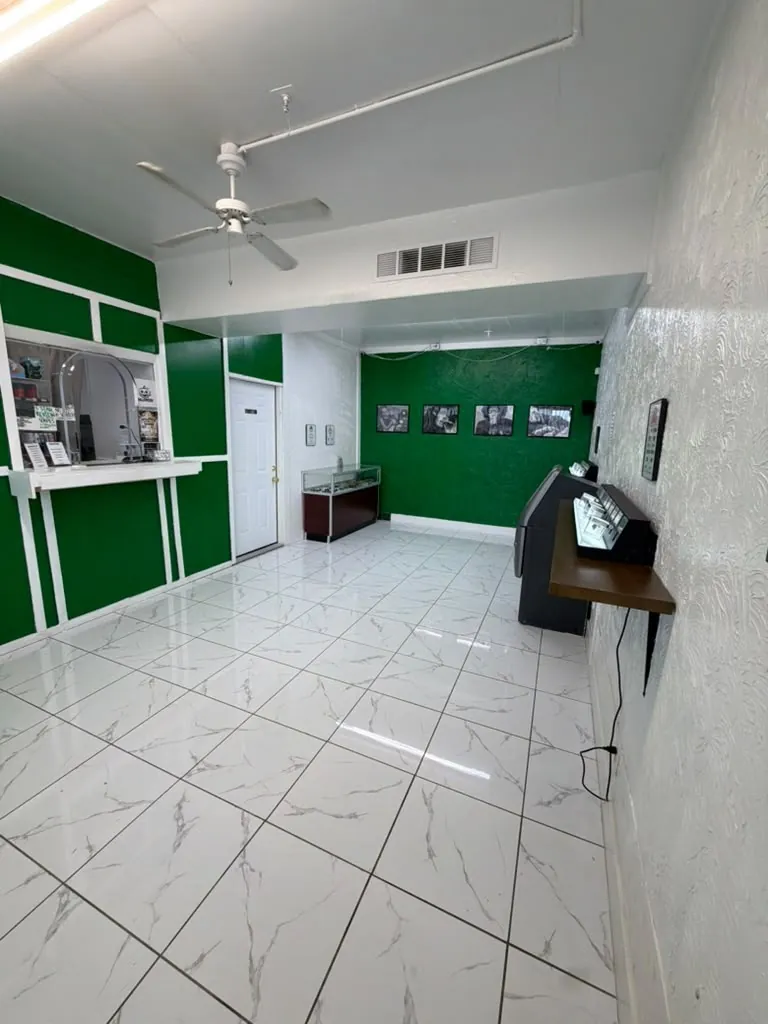 The bright sales floor with green walls and white marble tile at Kush Kingdom
