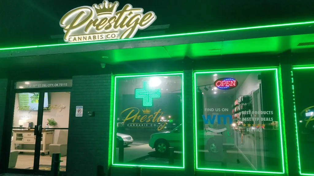 Prestige Cannabis Co. in Del City lit up in green at night