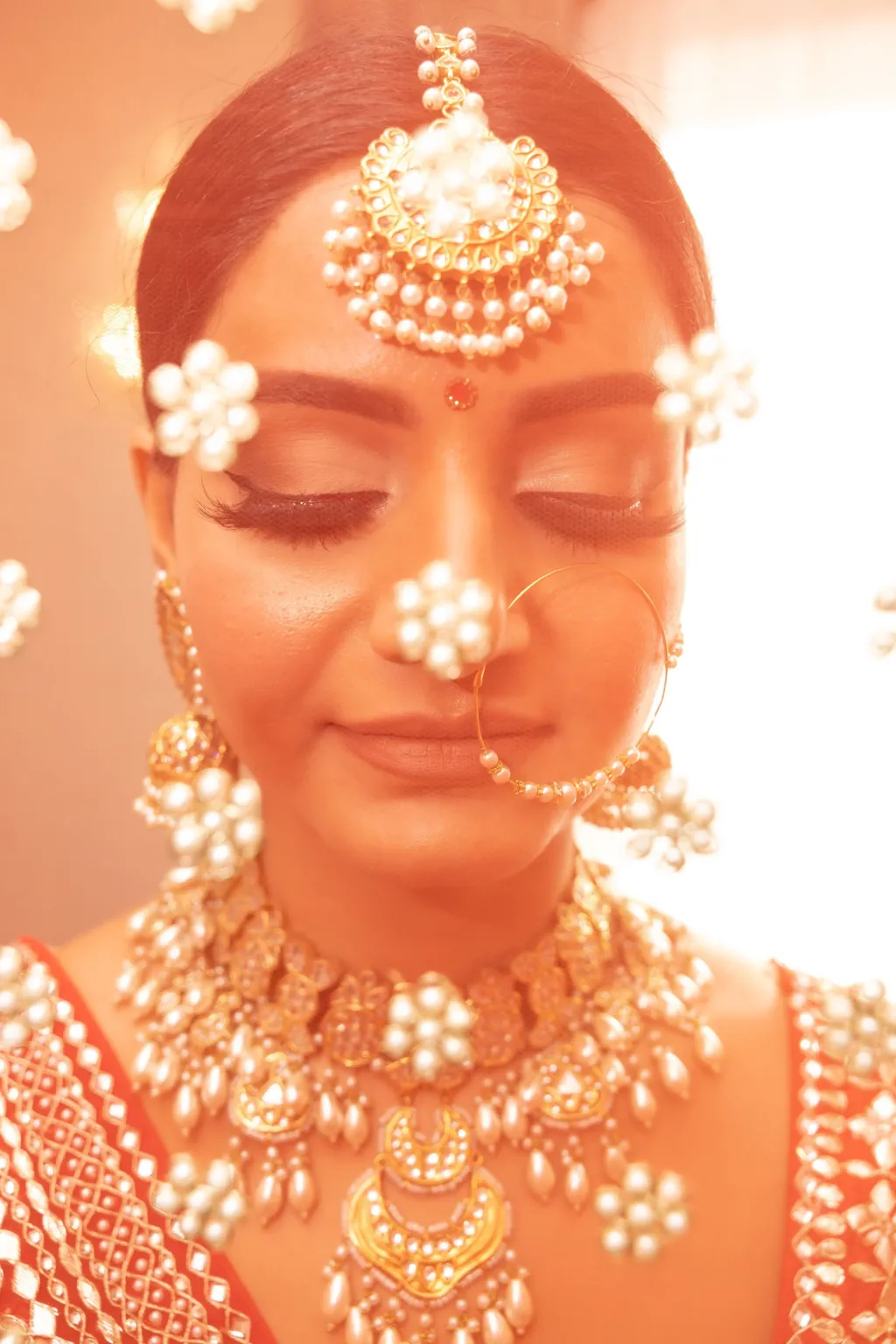 Close up of a bride in maang tikka and nath, eyes closed