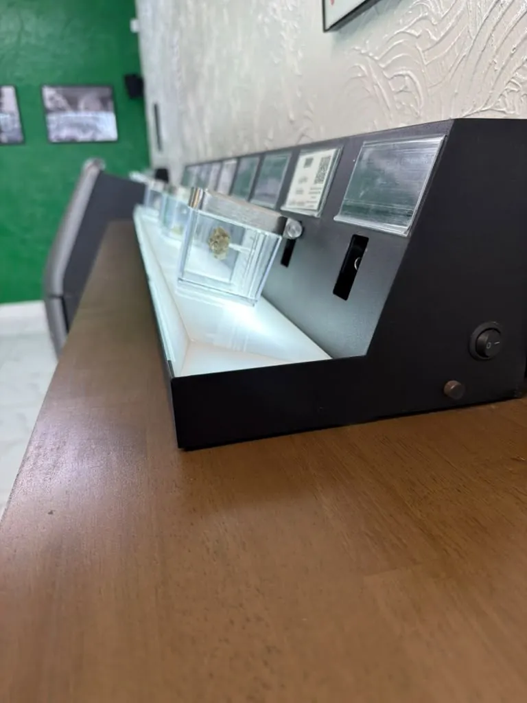 A row of display cases along the wall at Kush Kingdom