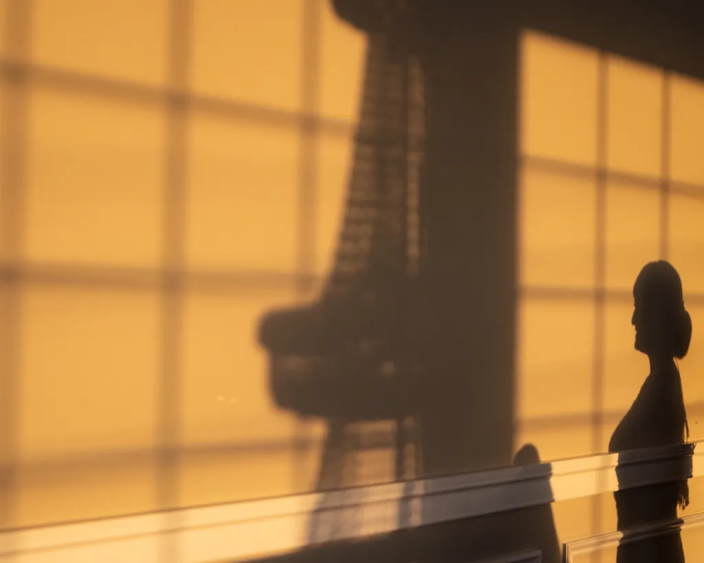Silhouettes of a couple cast on a warm wall